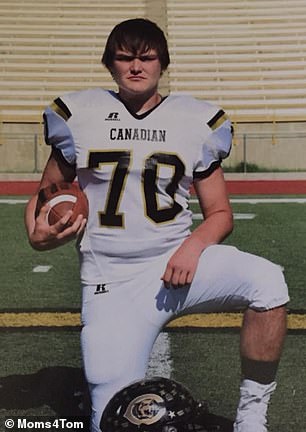 Tom Brown is pictured posing in his high school football uniform.